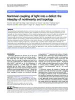 Nontrivial coupling of light into a defect: the interplay of nonlinearity and topology